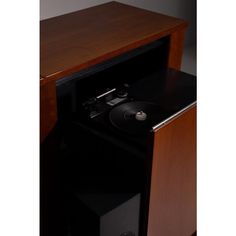 a record player is sitting on top of a cabinet