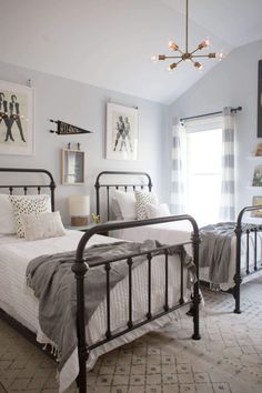 a bedroom with two beds and pictures on the wall