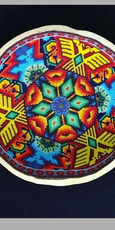 an oval shaped object with colorful designs on it