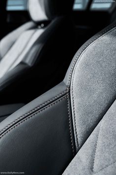 the interior of a car with black leather and grey stitching