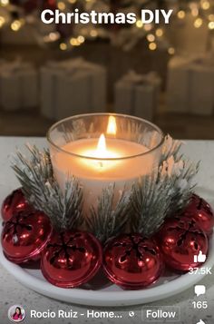 a candle is sitting on a plate with ornaments around it and the words christmas diy