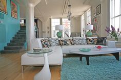 a living room filled with furniture and lots of windows