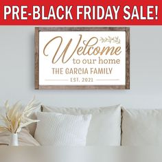 a welcome sign is displayed in front of a white couch with pillows on it and the words, pre - black friday sale