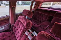 the interior of an old car with red velvet upholstered seats