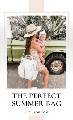 a woman holding a baby in her arms while standing next to a green truck with the words, the perfect summer bag