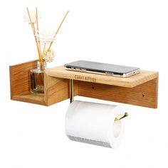 a wooden desk with a phone and toilet paper holder on the shelf next to it