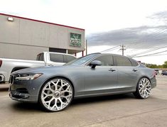 a silver car parked in front of a building