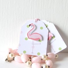 a pink flamingo gift tag surrounded by pearls