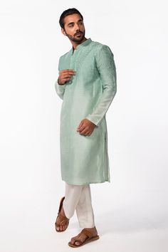 Aqua green full sleeve kurta with twirl embroidery and mandarin collared neckline. Paired with ivory pant pyjama.
Components: 2
Pattern: Embroidery
Type Of Work: Twirl
Neckline: Mandarin collar
Sleeve Type: Full sleeves
Fabric: Kurta: Bam Silk, Pant Pyjama: Cotton Silk
Color: Green
Other Details: 
Front concealed button placket
Occasion: Mehendi and Puja - Aza Fashions