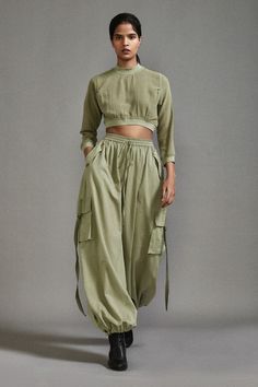 Green three fourth sleeves crop top in textured cotton with ribbed waistline, neckline and sleeve hem. Paired with a baggy-fit cargo pants with strap details on pockets. - Aza Fashions Rust Fabric, High Neck Crop Top, Baggy Cargo Pants, Eco Friendly Clothing, Ethical Clothing, Urban Wear, Cargo Pants Women, Cargo Pant, Sustainable Clothing