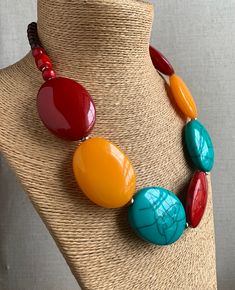 Large Oval bead statement Necklace. Colours: Turquoise, Mango Orange, Red, Marooon, Brown. The main beads are oval in shape, the Red and Turquoise beads have a crackle effect. Metal spacer beads. Fastens with a metal hook. Length: 59 cm. Largest bead: 5cm x 4 cm. HANDMADE & FAIRTRADE Items posted to addresses within the UK will be sent Royal Mail 1st Class UK Standard. International post will be sent Royal Mail International Tracked & Signed. Luxury Beaded Necklaces With Large Oval Beads, Cheap Red Beaded Necklace With Large Beads, Cheap Red Beaded Necklaces With Large Beads, Big Bead Necklace, Large Bead Necklace, Big Jewelry, Beaded Jewels, Handmade Fashion Jewelry, Beaded Statement Necklace