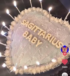 a birthday cake with candles on it that says sagitarus baby in the center