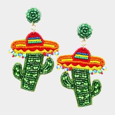 a pair of green and red earrings with a cactus in the shape of a sombrero