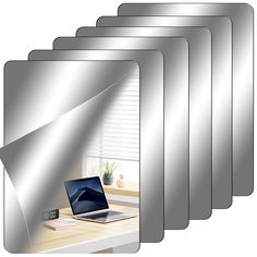 a set of six mirrors with a laptop on it