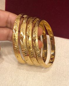 Christmas Gift, Holiday Gift,  Wedding Gold Bangles, Indian, African Bridal Bangles, 18k Gold Filled Bangles Gold Bangles for Women - Indian Bridal Bangles - Handmade Bracelet These stylish bangles feature a classic bangle design and are available in gold color. ▶ BEAUTIFUL HINGED GOLD BRACELET ▶ HIGED TO OPEN WIDE----- STAYS SECURELY SHUT ----- LIFT TAB SIDE TO OPEN Material: High quality 18 k gold filled bangles ( Not solid gold) Diameter: 2'56inches Can open Lead & Nickel free Tarnish resista Gold Jewelry With Shiny Finish For Wedding, Elegant Gold Round Bracelet, Gold Bangle With Elegant Design, Yellow Gold Bracelets With Shiny Finish For Wedding, Wedding Bangle With Shiny Finish, Yellow Gold Wedding Bracelets With Shiny Finish, Yellow Gold Round Bangle For Marriage, Gold Heavy Bracelets For Weddings, Wedding Bangle Jewelry With Shiny Finish