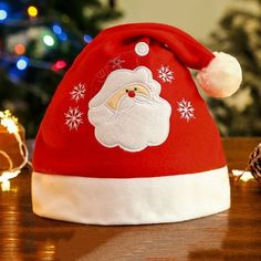 a santa claus hat sitting on top of a wooden table