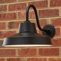 an outdoor light mounted on the side of a brick wall