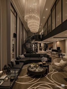 an elegant living room with chandelier and couches in the middle of it