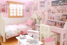 a doll house bedroom with pink and white decor on the walls, bed, desk, chair and dresser