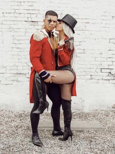 a man and woman dressed up in costume posing for the camera with their legs crossed