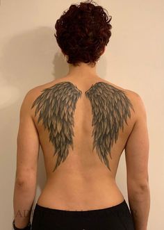 the back of a woman's body with wings on her upper and lower back