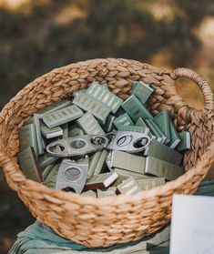 a basket filled with lots of green and silver items