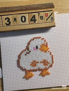 a close up of a cross stitch animal