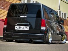 a black van parked in front of a building