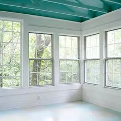 an empty room with three windows and no one in it