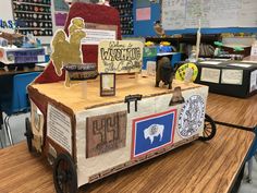 an old fashioned ice cream cart is decorated with paper and wood for the school fair