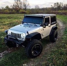 a jeep parked in the middle of a field