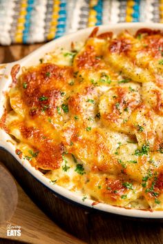 a casserole dish with cheese and parsley