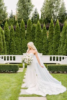 a woman in a wedding dress holding a bouquet