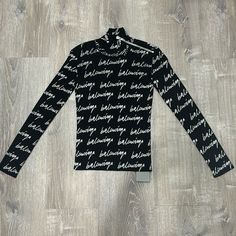 This Is A Balenciaga Long Sleeve Turtleneck Shirt In The Color Black, Size Small, Never Worn Great Condition Designer Long Sleeve Tops For Winter, Designer Long Sleeve Winter Tops, Designer Logo Print Tops For Winter, Designer Winter Tops With Logo Print, Designer Tops With Logo Print For Winter, Designer Fitted Crew Neck Top, Black Casual Tops With Signature Print, Casual Black Tops With Signature Print, Designer Black Tops With Logo Print