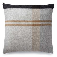 a grey and brown plaid pillow on a white background