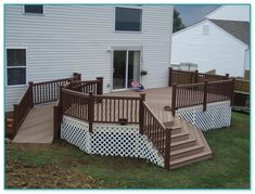 a deck with steps and railings in front of a house