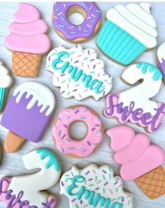 decorated cookies are arranged in the shape of ice cream, donuts and cupcakes