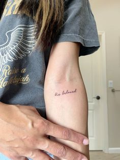 a woman with a tattoo on her arm and the words, not married written in cursive ink