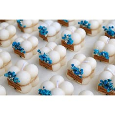 there are many small white eggs with blue decorations on them, and one is in a box