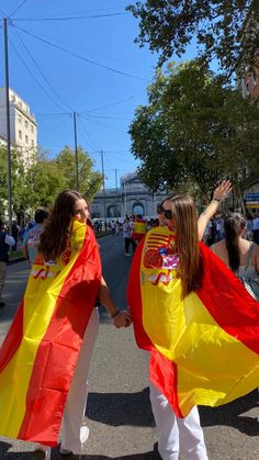 two women walking down the street holding flags