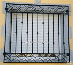 an iron window with bars on the outside