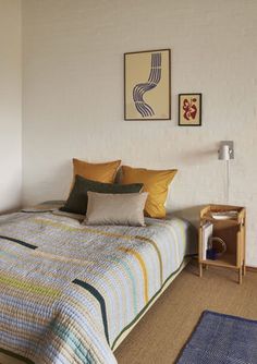 a bed sitting next to a window in a bedroom