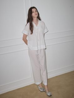 This pajama set features a relaxed fit for comfortable wear experience and collar design to add appeal to the item.- Availalbe in colors: Brown and white- Ribbon at the chest as a refined touch- Made from a soft fabric blend of cotton and tencel White Relaxed Fit Sets For Pajama Party, Spring White Relaxed Fit Sleepwear, Spring White Sleepwear With Relaxed Fit, White Relaxed Fit Sleep Set, White Sleepwear For Spring Relaxation, White Relaxed Fit Loungewear Sets, White V-neck Pajama Party Sets, Relaxed Fit Collared Sleepwear For Lounging, White Relaxed Fit Sleepwear For Daywear