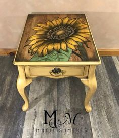 a small table with a painted sunflower on it