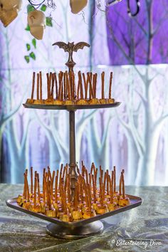 an elaborately decorated cake with candles in the shape of bats on it, sitting on a table