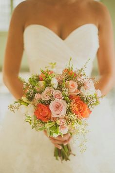 a bride holding a bouquet of flowers in her hands