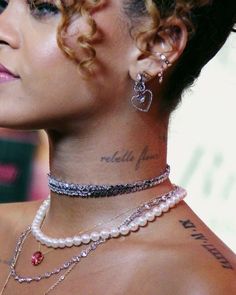 a woman with tattoos on her neck and chest