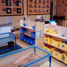 a room filled with lots of bins and shelves full of sand next to each other