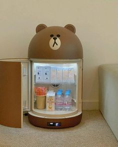 a brown bear shaped refrigerator sitting next to a wall