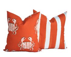 two orange and white pillows with elephants on them